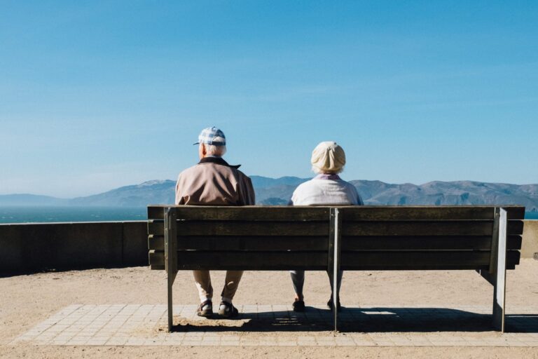 The "Digital Companion": How AI is Easing Loneliness for Seniors with Non-Invasive Conversational Interfaces - SentiSight.ai A senior couple sitting on a bench. Image credit: Matt Bennett via Unsplash, free license